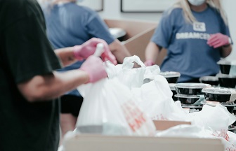 volunteers putting together bags to help the poor in their local area